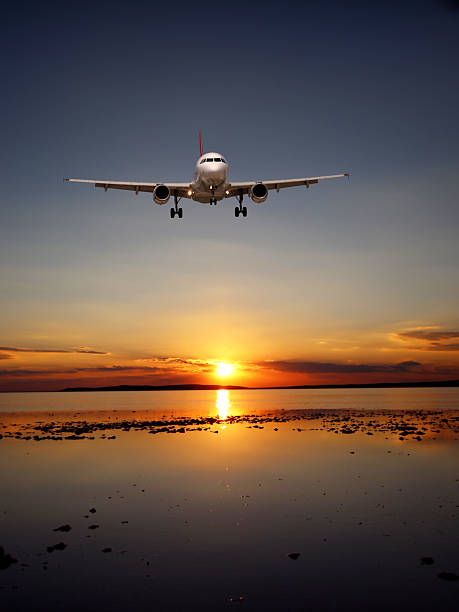 istock Airplane Landing at Sunset Over Wet Runway 2214176531