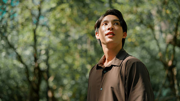 istock Asian man walking in public park 2214180945