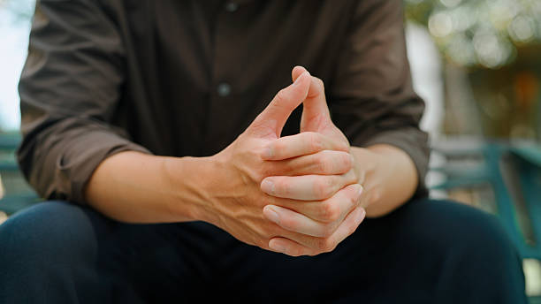 Asian man holding hands himself