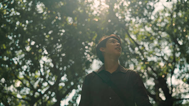 istock Asian man walking in public park 2214181902