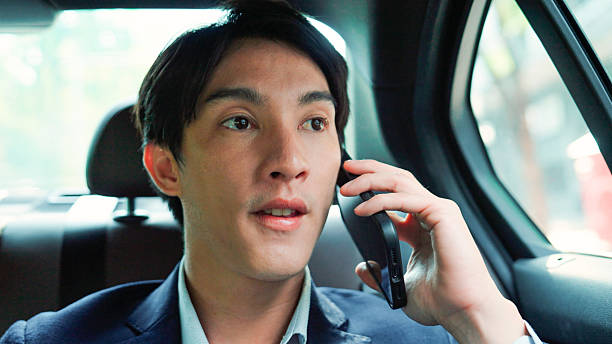 istock Businessman talking on phone while sitting in car 2214182010