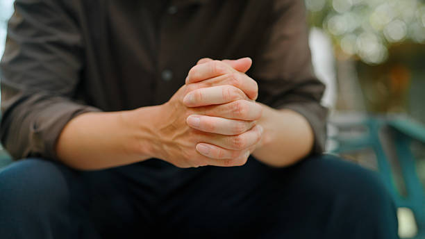 asian man holding hands himself - うつ病 治る ストックフォトと画像
