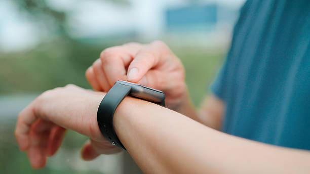 istock Asian young man using smart watch in public park 2214182550