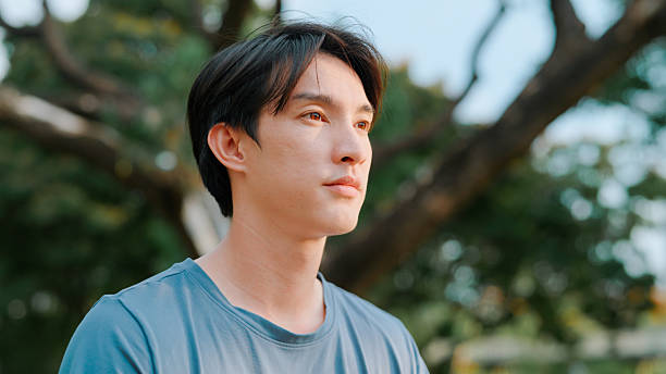 istock Asian man doing meditating in public park 2214182630