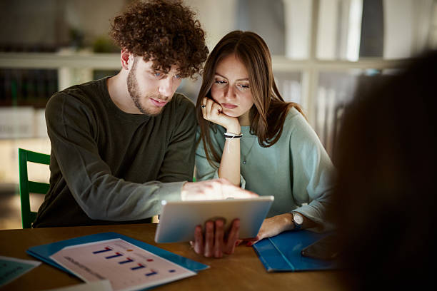 istock Young creative couple working on touchpad in the office. 2214182807
