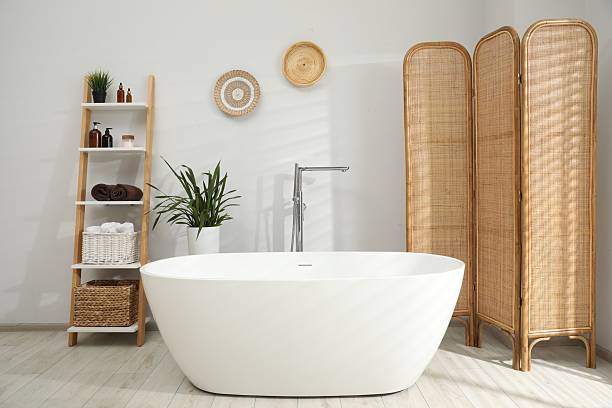 istock Stylish bathroom interior with folding screen and tub 2214182930