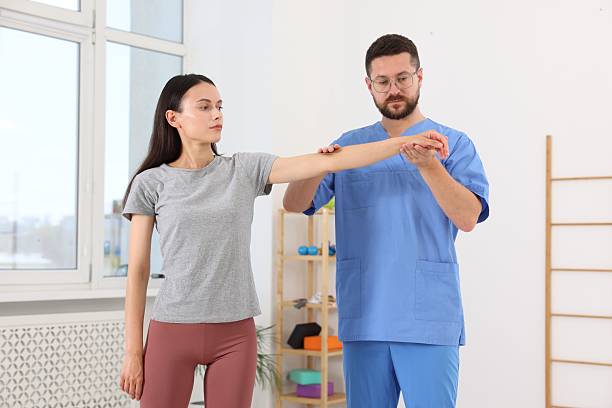 istock Physiotherapist working with patient in rehabilitation center 2214185267