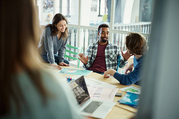 istock Happy black freelancer talking to his colleagues at casual office. 2214185268