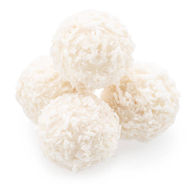 istock Round white chocolate candies covered with blanched coconut on white background. File contains clipping path. 2214185494