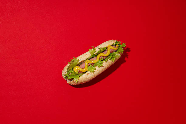 istock Hot dog with sauce on red background, top view 2214185746