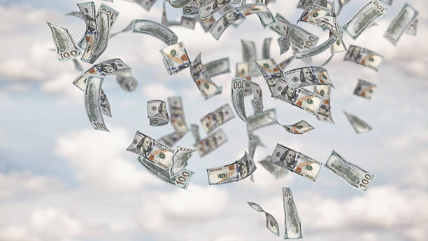 istock Flying currency creates a striking visual display against a cloudy sky. 3D illustration 2214186343