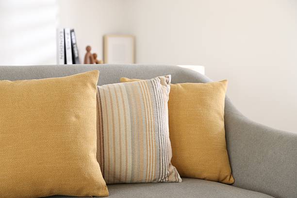 istock Different soft pillows on gray sofa in living room 2214186516