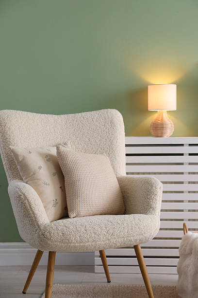 istock Two soft pillows on light armchair in living room 2214186519