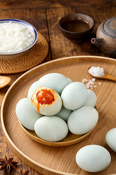 istock Salted duck eggs, a type of hand-pickled egg, are placed on a wooden table indoors 2214187729