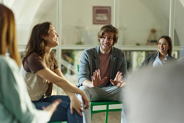 istock Happy creative colleagues talking on a casual meeting in the office. 2214188329