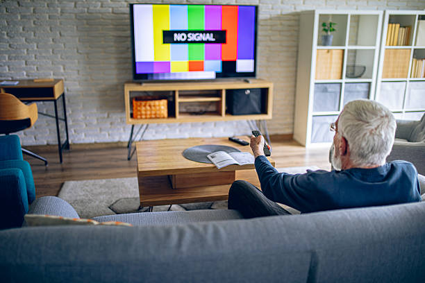 istock Senior man having a problem with TV signal 2214188664