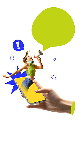 istock Energetic woman shouts through megaphone while emerging from phone with exclamation and stars. 2214189273