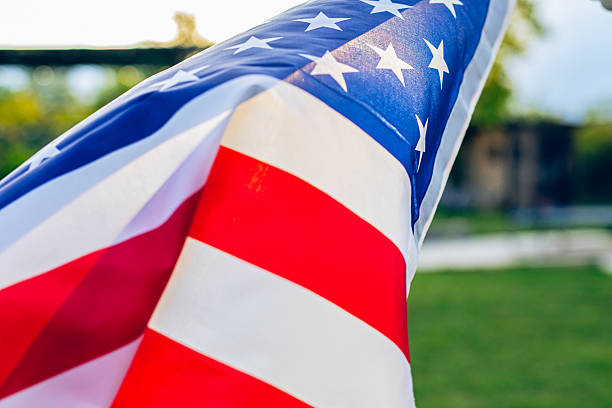istock American flag waving on wind in backyard 2214189421
