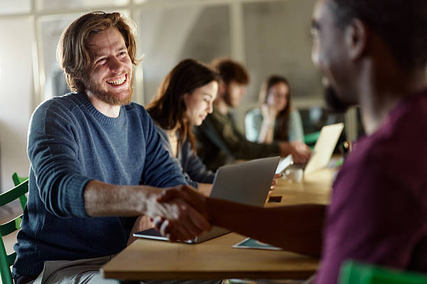 istock Happy creative men shaking hands on a meeting in the office. 2214190927