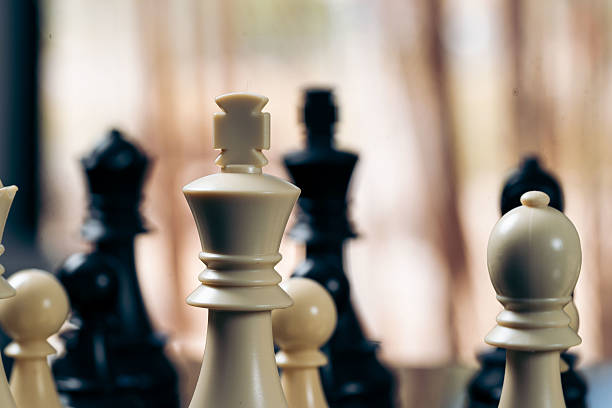 istock White king standing in front of black king on chessboard 2214191291