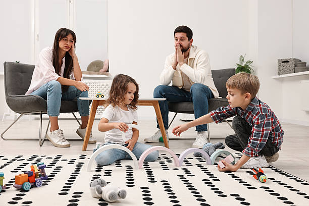 istock Hyperactive children playing and their overwhelmed parents at home 2214191319