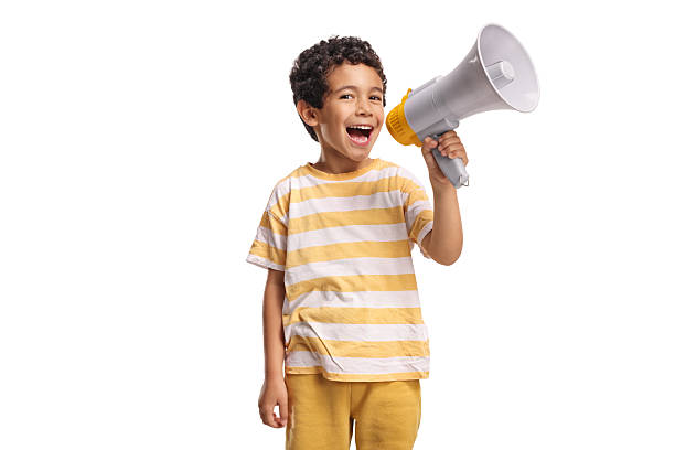 istock Cheerful boy shouting and holding a megaphone 2214192257