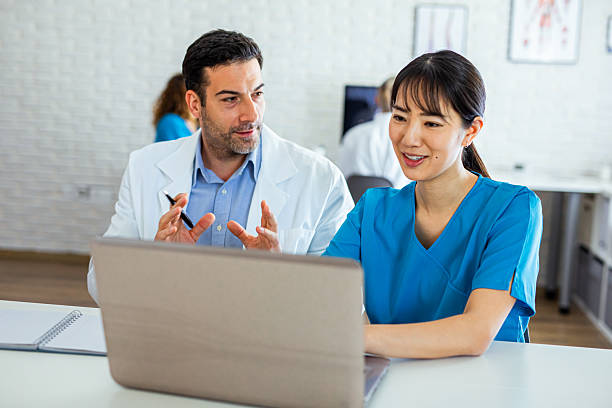 istock Attending doctor showing his student a solution of a medical issue 2214192456