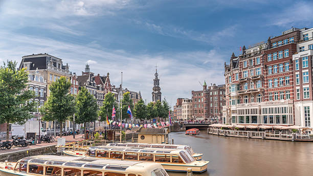 istock Panoramic timelapse hyperlapse of Amsterdam city center featuring Amstel River, waterfront and Munttoren tower. Netherlands 2214196196