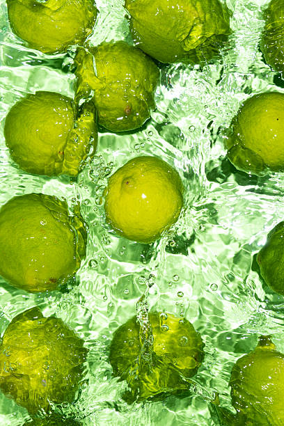 istock Green Limes on Water Surface Flat Lay Vertical 2214198000