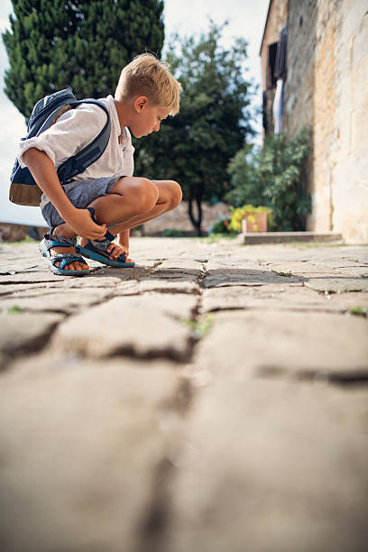 istock Young traveler observing ants on a stone pathway 2214199235