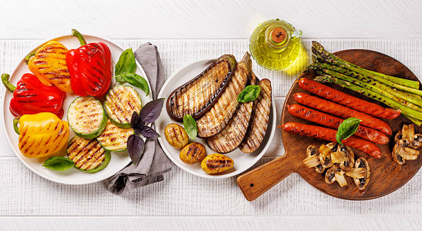 istock Assorted grilled vegetables including bell peppers, zucchini, eggplant, and sausages 2214200278