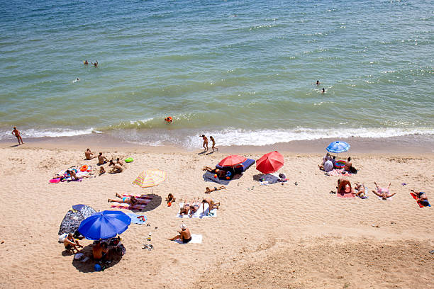 Beach umbrellas and people sunbathing