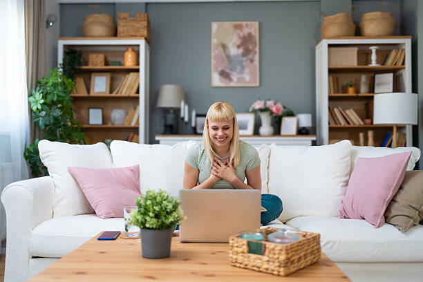 istock Young freelance business woman having video call conference on laptop computer while sitting and working at home, talking on webcam with potential investor in her project. Finance and economy concept. 2214201518
