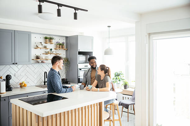 istock Multiethnic couple enjoying coffee at home with friends 2214201871