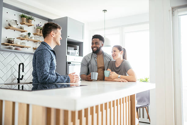 istock Multiethnic couple enjoying coffee at home with friends 2214201873