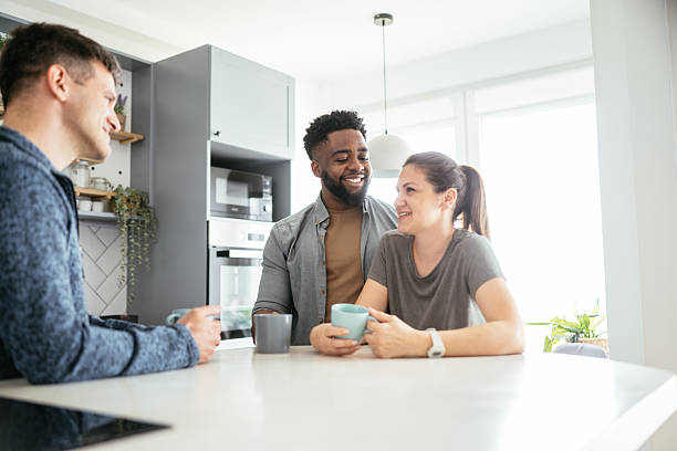 istock Multiethnic couple enjoying coffee at home with friends 2214201889