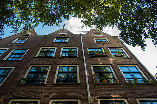 istock Upward view of Amsterdam building with sky 2214204738