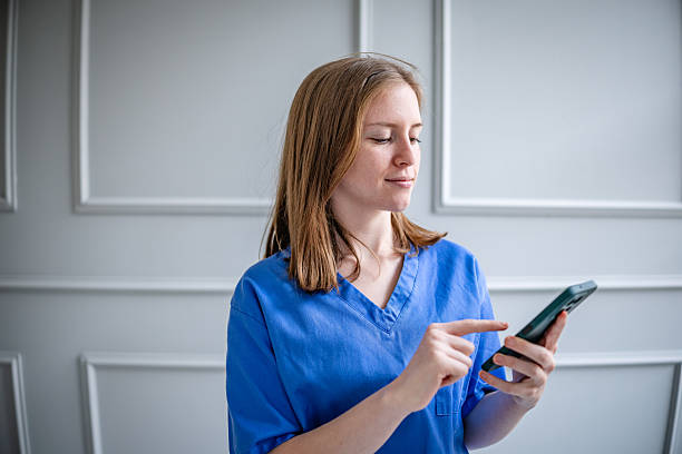 istock Young female nurse using smartphone while on duty in a modern healthcare setting 2214207645