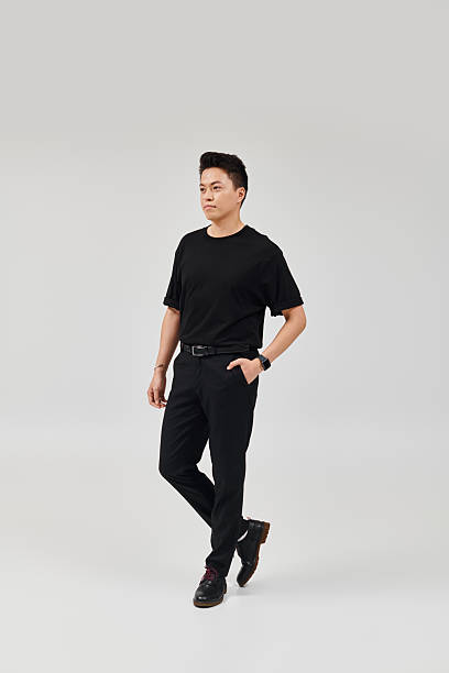 istock Stylish young man displays modern fashion in a minimalistic studio setting 2214212291
