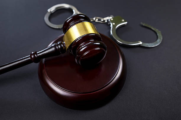 istock judge's gavel and handcuffs on a black background 2214215383