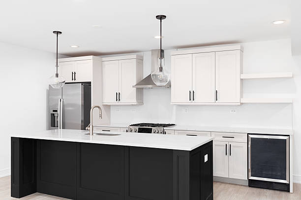 istock A kitchen with off white cabinets, black island, and marble countertops. 2214220161