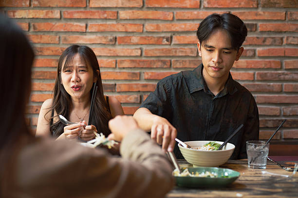 istock Friends eating together in restaurant and having fun 2214221648