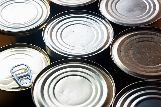 Round tin cans with food on the surface