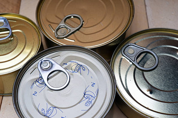 Round tin cans with food on the surface