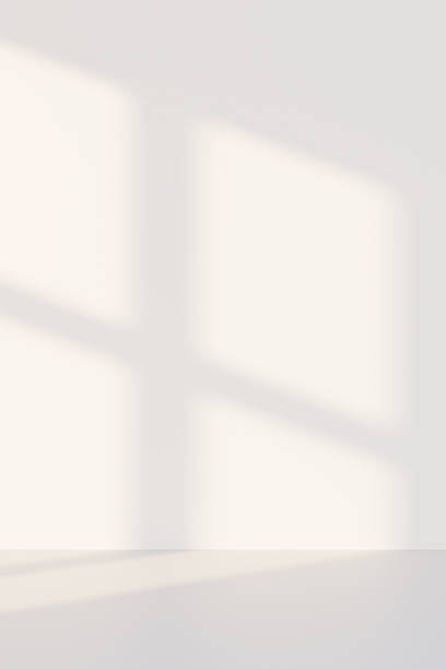 istock 3D white studio room with a window shadow on the wall. Sunlight moves across the empty room. Background for product display, with space for text. 2214226538