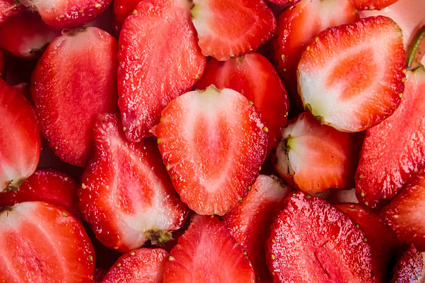 istock a pile of strawberries cut in half as a background 2214227901