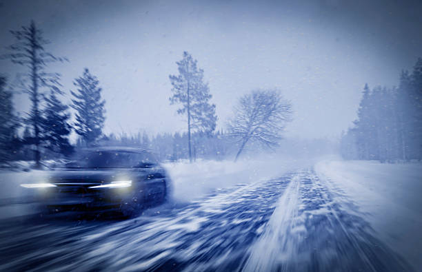 Motion Blur of Car Driving Down Snow Covered Road