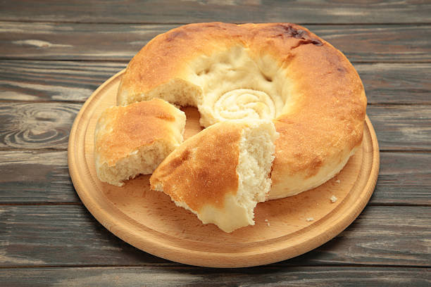 istock Georgian traditional bread flatbread on brown wooden background. 2214232059