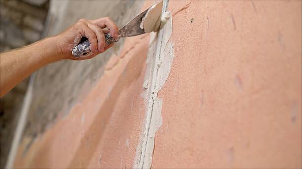 istock Applying plaster using a spatula, close-up. The process of applying plaster to a metal track in a wall. 2214233094