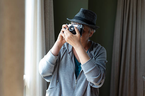 Mature woman is holding a camera